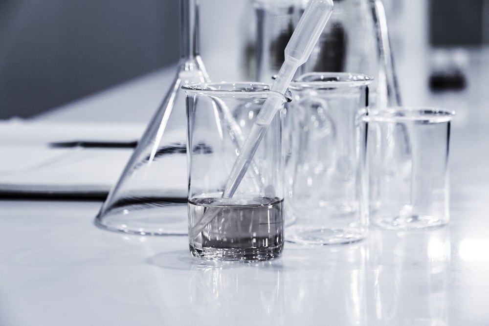 Laboratory glassware and a pipette on a lab bench